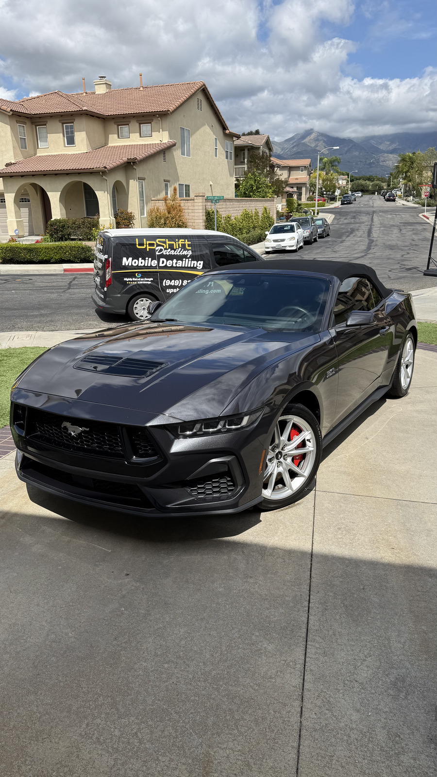 Ford Mustang GT convertible after ceramic coating, mountain backdrop